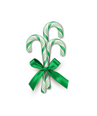Three green striped candy canes with green bow isolated on white background. Vector Christmas and New Year design element.