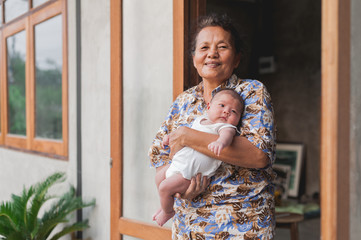Asian Grandmother holding her Grandson