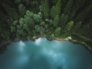 Aerial drone view of blue lakes and green forests. Beautiful summer panorama. National park in Romania
