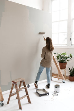 Girl painting background at photo studio