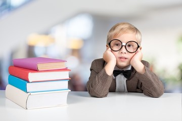 Two little boys studying subject on background