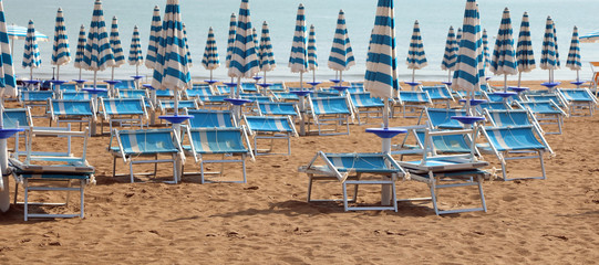 Beach with many deck chair and umbrellas