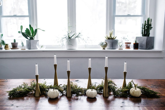 Candlesticks on Table and Assorted Cacti on Windowsill in Dining Room