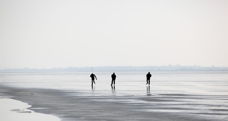 flying dutchmen: three anonymous friends skating on a frozen lake
