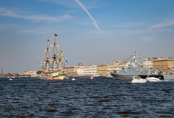 Sailboat and warship at the celebration of the Navy in St. Petersburg