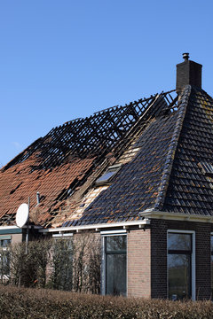 Old farmhouse with burned down roof
