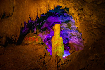 Beautiful illuminated multicolored stalactites in Danzhou Stone Flower Caves, Geopark next to Haikou, Hainan, China