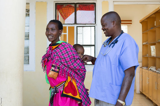 Doctor examining Mother and Baby. - Powered by Adobe