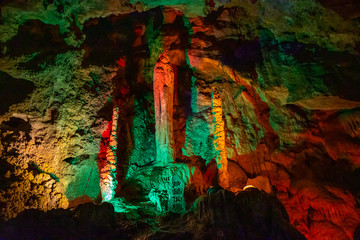 Beautiful illuminated multicolored stalactites in Danzhou Stone Flower Caves, Geopark next to Haikou, Hainan, China