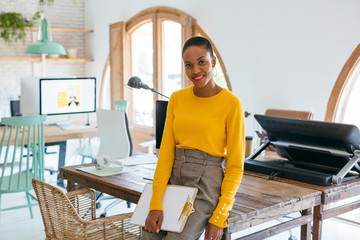 Portrait of a black woman in a modern office.