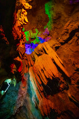 Beautiful illuminated multicolored stalactites in Danzhou Stone Flower Caves, Geopark next to Haikou, Hainan, China