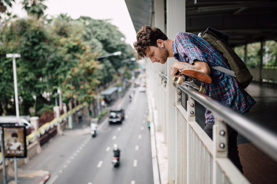 Portrait of young man in Bangkok observing traffic