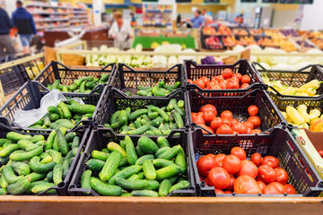 Fresh vegetables in plastic boxes in supermarket