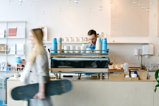 Woman leaving coffeehouse