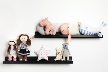 Different stuffed toys on shelves in child room