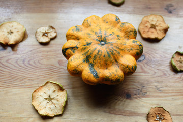 Harvest of yellow squashes with cut dry apples on the table