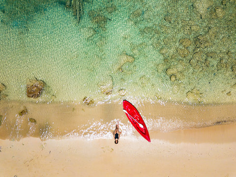 Woman resting on the beach after kayaking, Malaysia