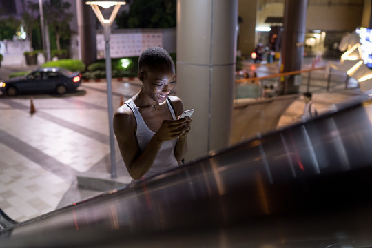 Night portrait of a woman on escalator