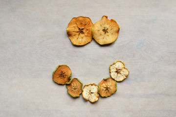 Decor of smiling pieces of dry apples