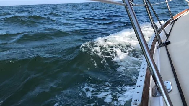 Onboard Sailboat with Waves Crashing Against Hull