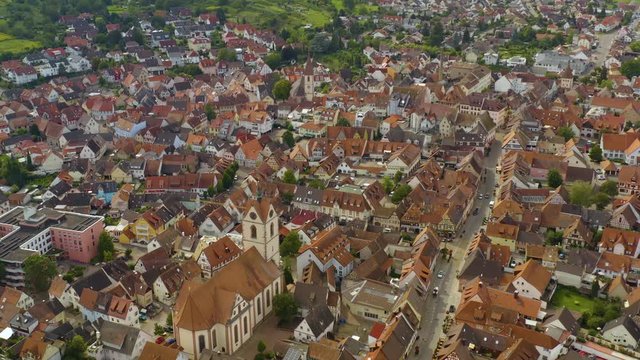 Aerial view of the city Endingen am Kaiserstuhl in germany on a sunny day in summer. Tilt up from the old town to the horizon.