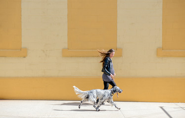 Pregnant Woman Walks her Dog in the City