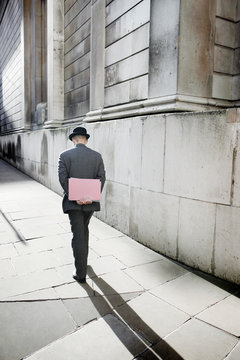 A city workerwalks along a street