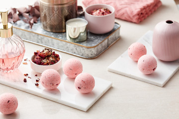 Rose bath bombs on marble boards.