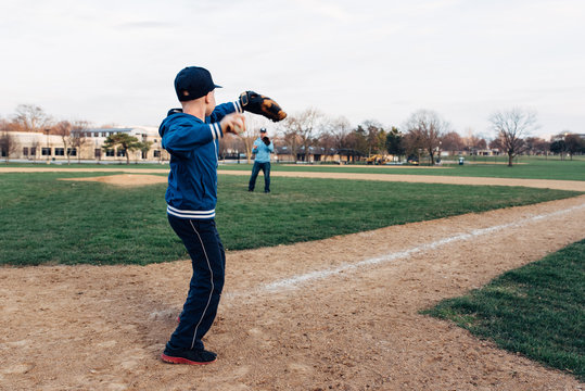 Son throwing a ball to his Dad - Powered by Adobe
