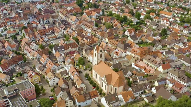Aerial view of the city Endingen am Kaiserstuhl in germany on a sunny day in summer. Pan to the left around the church.