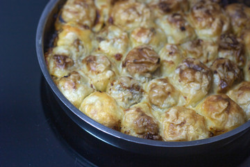 A piece of Bosnian style burek. It is a pastry filled with seasoned meat and onions and baked in an oven. Traditional Bosnian pastry- manti borek