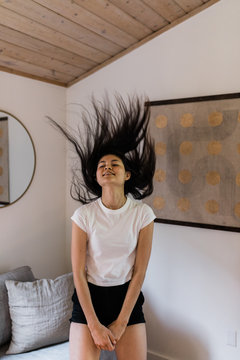 woman flipping hair back while dancing