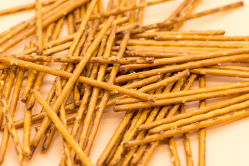 snack consist of salty sticks on pink background
