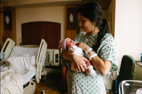 Mother hold newborn baby in hospital room