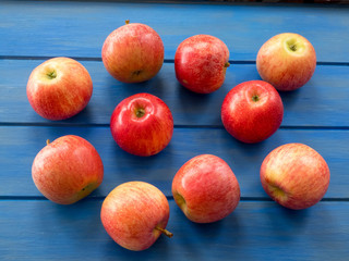 Group of fresh apples, pink  and green,   on the blue table.
