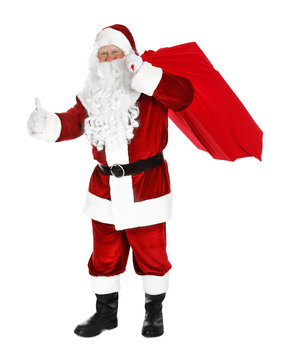 Authentic Santa Claus with bag full of gifts on white background