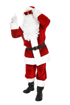 Authentic Santa Claus wearing sunglasses on white background