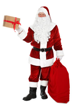 Authentic Santa Claus with sack and gifts on white background