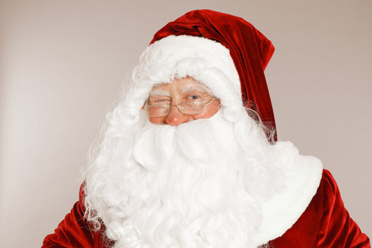 Happy authentic Santa Claus on grey background
