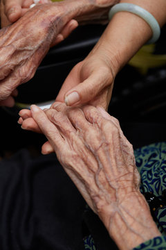 Closeup of hands, hands of the elderly and children together