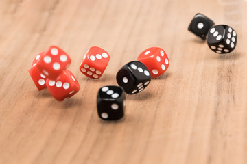 Playing dice in the game over a wooden table, a game of roulette. The concept of gaming addiction, entertainment.
