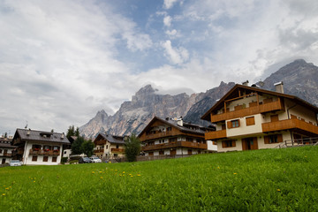 Fototapeta na wymiar Cozy Alpine Buildings in Dolomite Alps mountains in Italy. Cordtina de Ampezzo, Italy