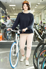 Fototapeta na wymiar woman in helmet standing with sport bicycle