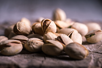 still life of isolated pistachios in the foreground in studio.