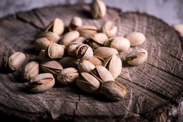 still life of isolated pistachios in the foreground in studio.
