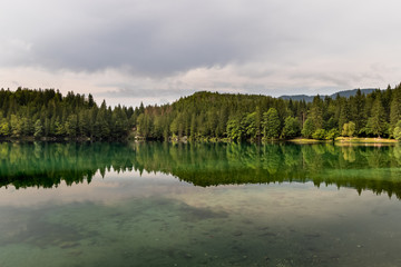 Beautiful and colorful Alpine Lake in Nother Italy in cloudy day. Alps region of Italy