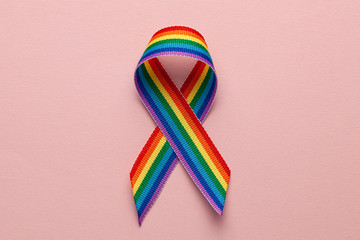 LGBT rainbow ribbon pride symbol. Stop homophobia. Pink background