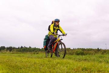 cyclist traveler rides through the natural landscape