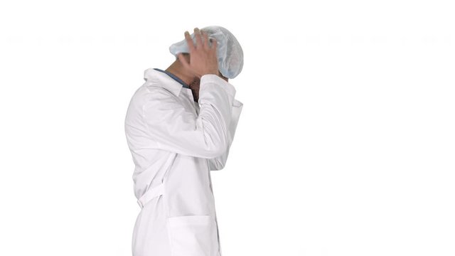 Arabic doctor walking and putting medical cap on on white background.