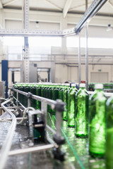Bottling plant - Water bottling line for processing and bottling pure spring water into small bottles. Selective focus.